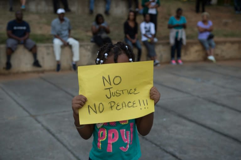 A little girl holds up a sign during a demonstration against police brutality in Charlotte, North Carolina, on September 21, 2016
