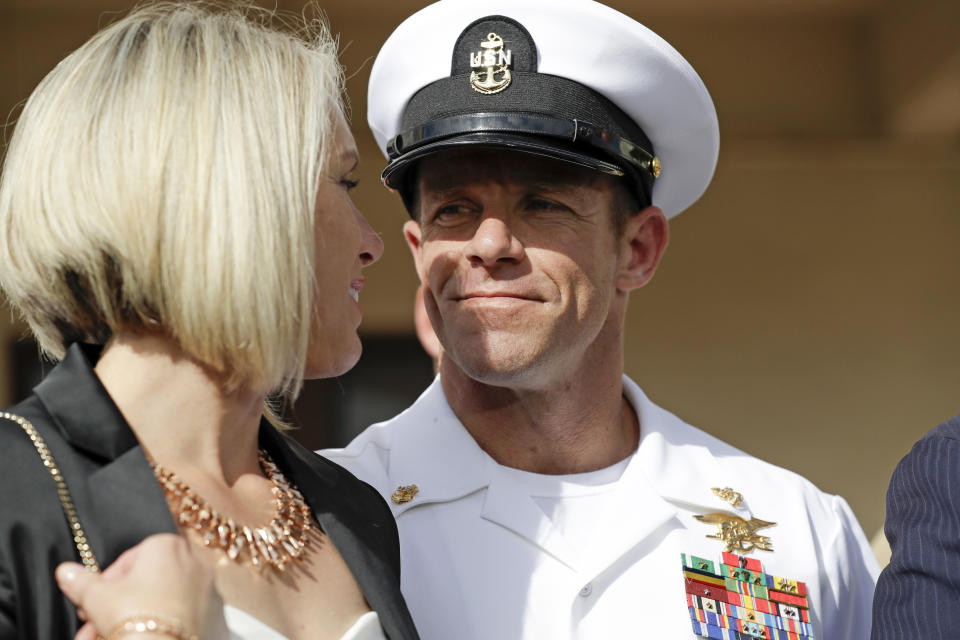 FILE - In this July 2, 2019 file photo, Navy Special Operations Chief Edward Gallagher, right, walks with his wife, Andrea Gallagher as they leave a military court on Naval Base San Diego, in San Diego. The acting Navy secretary has canceled a peer-review process for three Navy SEALs who supervised a fourth SEAL convicted of posing with a dead teenage prisoner in Iraq. Acting Navy Secretary Thomas Modly said Wednesday, Nov. 27, 2019, the case was becoming a distraction. The decision comes after President Donald Trump intervened in the case of Gallagher. (AP Photo/Gregory Bull, File)