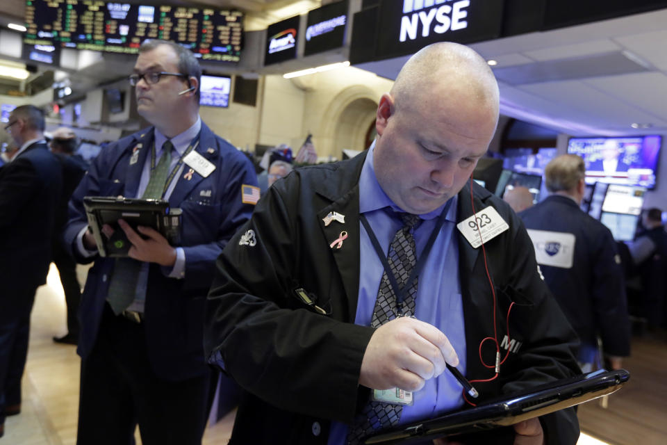 Trader Michael Casey, right, works on the floor of the New York Stock Exchange, Wednesday, March 29, 2017. Stocks are opening mostly lower on Wall Street led by declines in utilities and real estate companies. (AP Photo/Richard Drew)