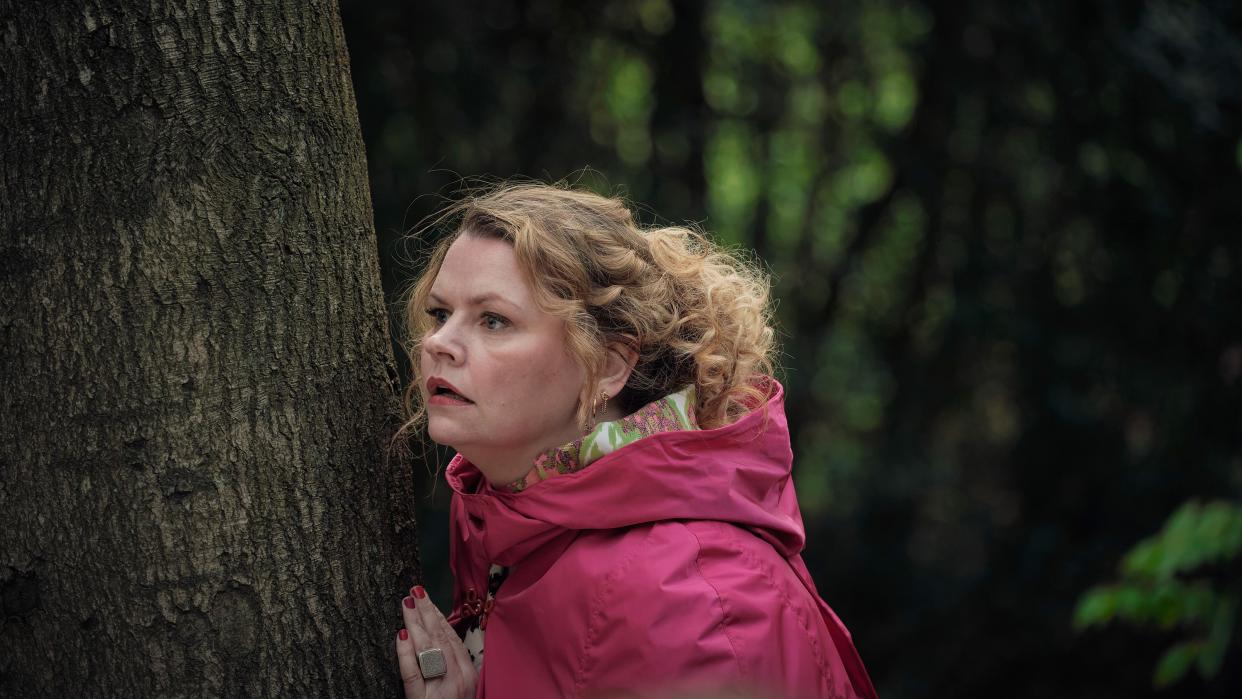  Alice (Rebekah Staton) peers round a tree in The Following Events Are Based On A Pack Of Lies 