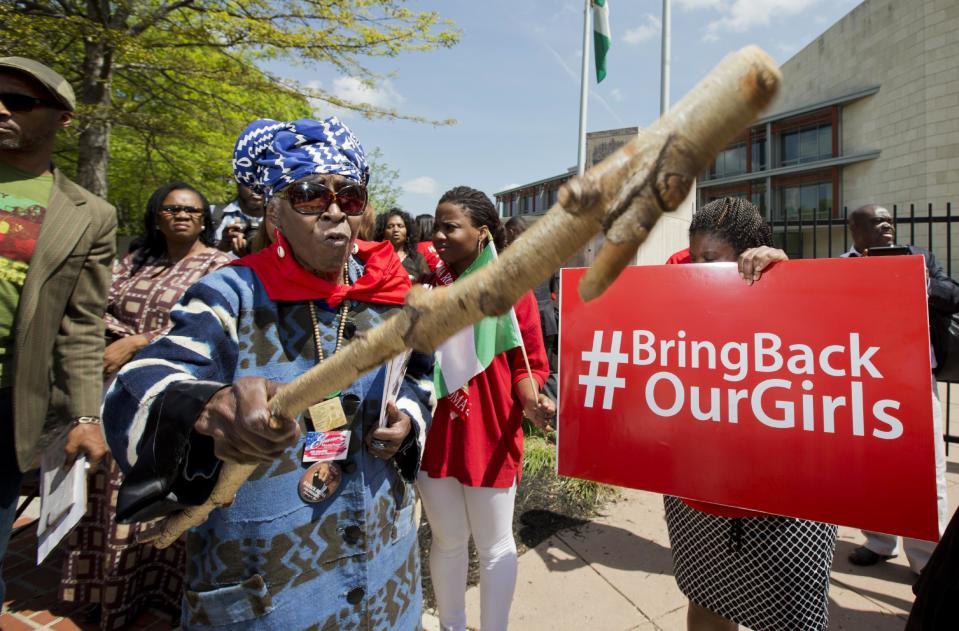 Mia Kuumba, of the District of Columbia, brandishes a wooden stick during a rally in front of the Nigerian embassy in northwest Washington, Tuesday, May 6, 2014, protesting the kidnapping of nearly 300 teenage schoolgirls, abducted from a school in the remote northeast of Nigeria three weeks ago. (AP Photo/Manuel Balce Ceneta)