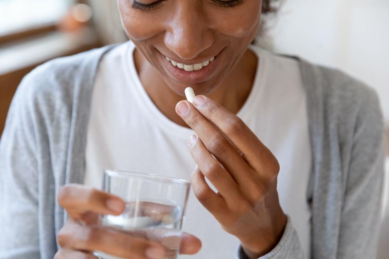 young woman taking vitamins