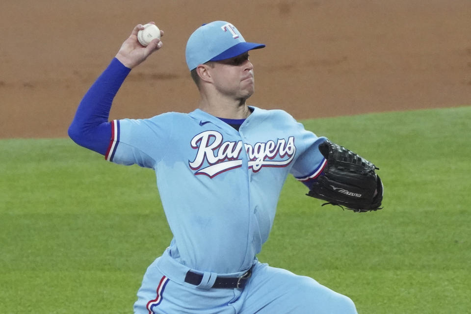 Texas Rangers starting pitcher Corey Kluber throws against the Colorado Rockies in the first inning of a baseball game Sunday, July 26, 2020, in Arlington, Texas. Kluber was removed from the game after one inning. (AP Photo/Louis DeLuca)