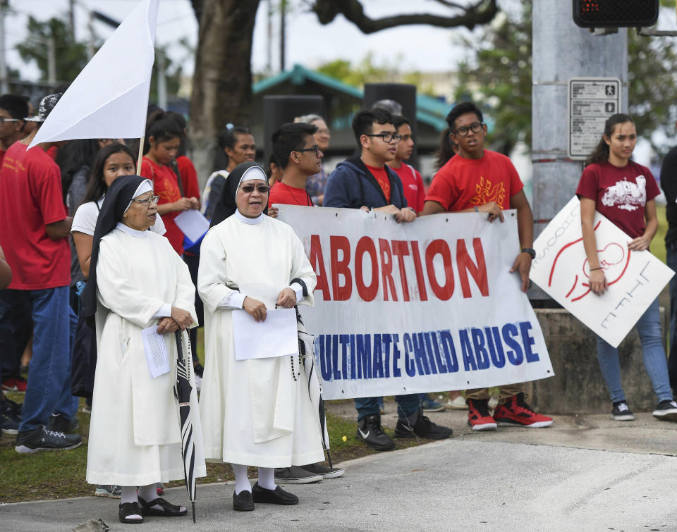 In this Jan. 22, 2017, photo, the Guam Catholic Pro-Life Committee holds its annual "Chain for Life" protest against abortion at the Guam International Trade Center intersection in Tamuning, Guam. The first female governor of Guam says she's concerned that a lack of abortion access in the U.S. territory means women will be forced to seek illegal or dangerous alternatives. (Frank San Nicolas/The Pacific Daily via AP)