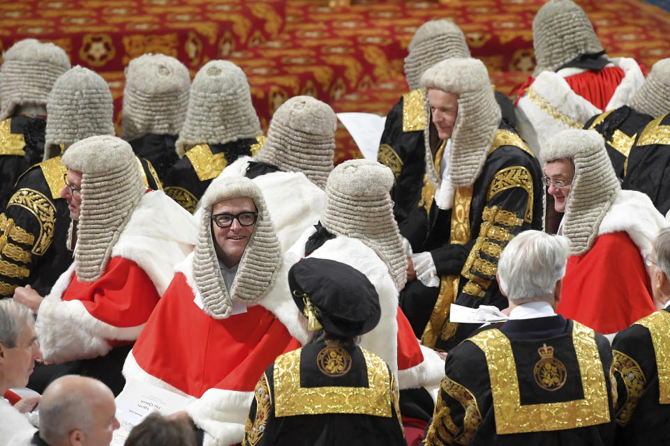 Guests in the House of Lords await the arrival of Queen Elizabeth II for the official State Opening of Parliament in London, Monday Oct. 14, 2019. (Toby Melville/Pool via AP)