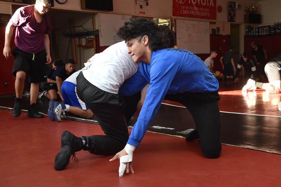 Nordhoff High senior Armando Gomez wrestles against Fillmore High's Adrian Scott during a practice session at Rio Mesa High involving several area wrestlers who will compete in the CIF-Southern Section Individual Championships on Friday and Saturday. Doctors told Gomez he would never wrestle again after an accident nine months ago sliced a good share of six of his fingers. Instead, he won his second straight Citrus Coast League title and qualified for the CIF Individuals.