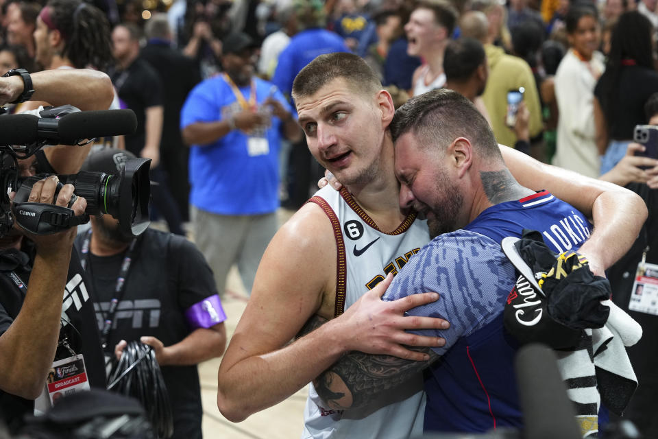 Denver Nuggets center Nikola Jokic, center, celebrates after the team won the NBA Championship with a victory over the Miami Heat in Game 5 of basketball's NBA Finals, Monday, June 12, 2023, in Denver. (AP Photo/Jack Dempsey)