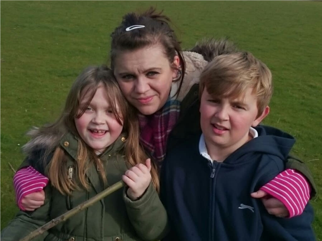 Claire Griffiths, pictured with her children, she is now suing her surgeon after a rectopexy operation left her in pain. (Supplied, Claire Griffiths)