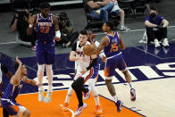 Miami Heat guard Tyler Herro passes as Phoenix Suns guard Cameron Payne (15) defends during the first half of an NBA basketball game, Tuesday, April 13, 2021, in Phoenix. (AP Photo/Matt York)