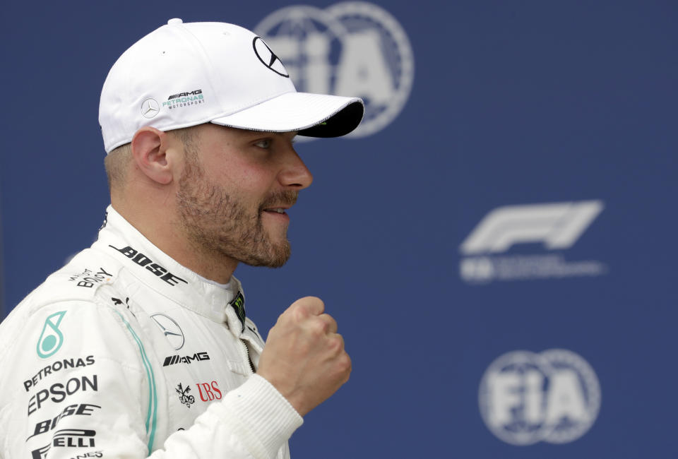 Mercedes driver Valtteri Bottas of Finland celebrates after he clocked the fastest time during the qualifying session at the Silverstone racetrack, in Silverstone, England, Saturday, July 13, 2019. The British Formula One Grand Prix will be held on Sunday. (AP Photo/Luca Bruno)