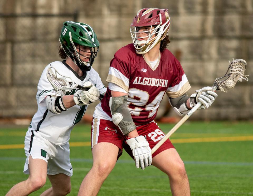 Wachusett’s Malachi Leary keeps pressure on as Algonquin’s Luke Harwich looks to pass from behind the goal Thursday, April 6, 2023.