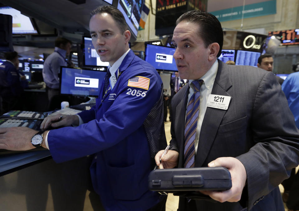 Specialist Jason Hardzewicz works with trader Tommy Kalikas on the floor of the New York Stock Exchange, Tuesday, April 22, 2014. Stock futures edged higher as more companies reported first quarter earnings. (AP Photo/Richard Drew)