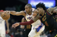 Philadelphia 76ers' Al Horford, left, and Cleveland Cavaliers' Kevin Porter Jr. battle for a loose ball in the first half of an NBA basketball game, Wednesday, Feb. 26, 2020, in Cleveland. (AP Photo/Tony Dejak)