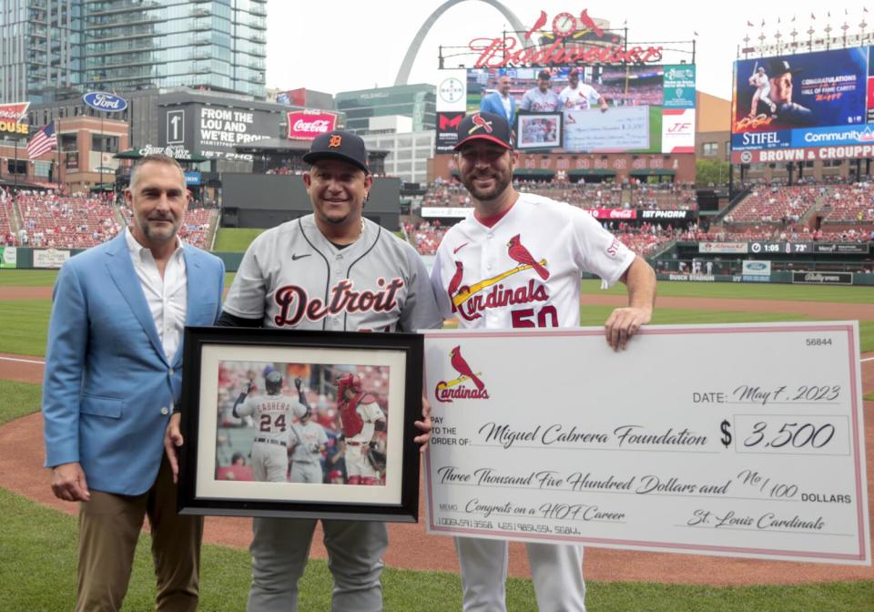 Miguel Cabrera, middle, stands with St. Louis Cardinals' Adam Wainwright, right, and GM John Mozeliak