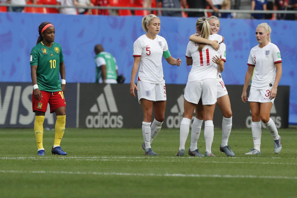 England players celebrate at the end of the Women's World Cup round of 16 soccer match between England and Cameroon at the Stade du Hainaut stadium in Valenciennes, France, Sunday, June 23, 2019. England beat Cameroon 3-0. (AP Photo/Michel Spingler)