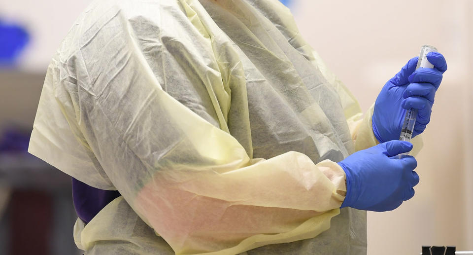 Generic picture of a nurse putting on PPE amid the coronavirus pandemic