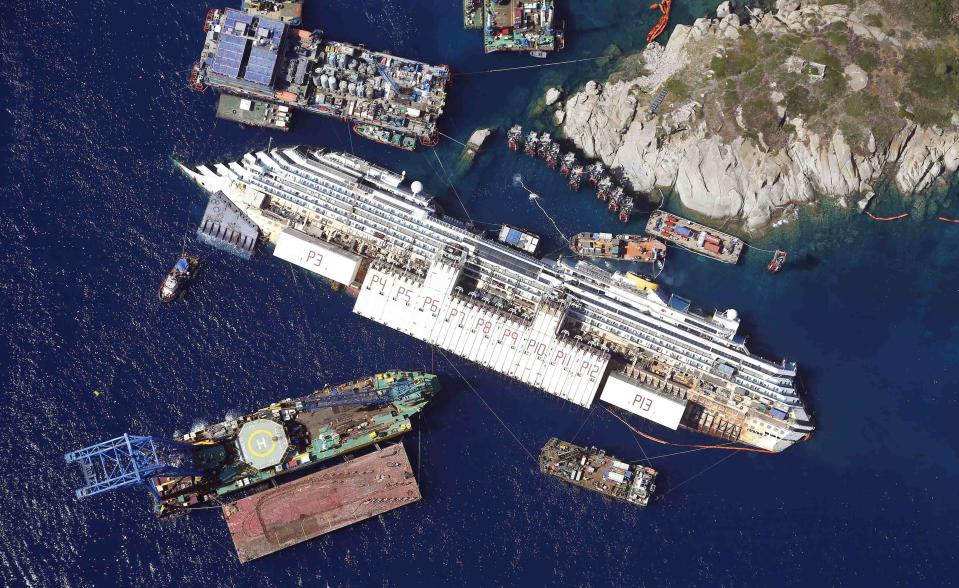 An aerial view shows the Costa Concordia as it lies on its side next to Giglio Island taken from an Italian navy helicopter in this August 26, 2013 file photo.(REUTERS/Alessandro Bianchi/Files)