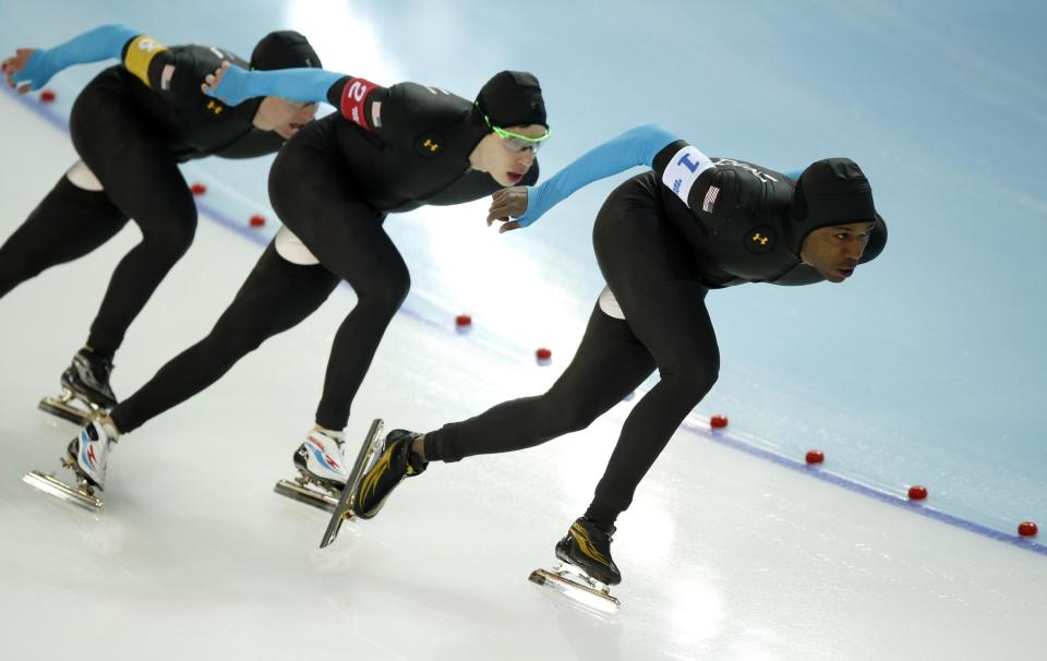 The U.S. speedskating team, left to right, Jonathan Kuck, Brian Hansen and Shani Davis compete in the men's speedskating team pursuit quarterfinals at the Adler Arena Skating Center during the 2014 Winter Olympics in Sochi, Russia, Friday, Feb. 21, 2014. (AP Photo/Pavel Golovkin)