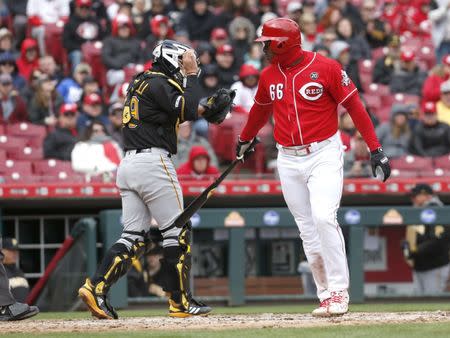 Mar 31, 2019; Cincinnati, OH, USA; Cincinnati Reds right fielder Yasiel Puig (66) looks back at Pittsburgh Pirates catcher Francisco Cervelli (29) after striking out during the sixth inning at Great American Ball Park. Mandatory Credit: David Kohl-USA TODAY Sports