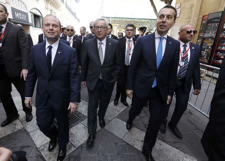 Maltese Prime Minister Joseph Muscat (L), EU Commission President Jean-Claude Juncker (C) and Austrian Prime Minister Christian Kern, walk through Valletta during a break in the European Union leaders summit in Valletta, Malta, February 3, 2017. REUTERS/Yves Herman