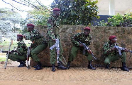 Policemen from the General Service Unit (GSU) take cover from stone throwing youths during the "Saba Saba Day" rally at the Uhuru park grounds in the capital Nairobi July 7, 2014. REUTERS/Noor Khamis