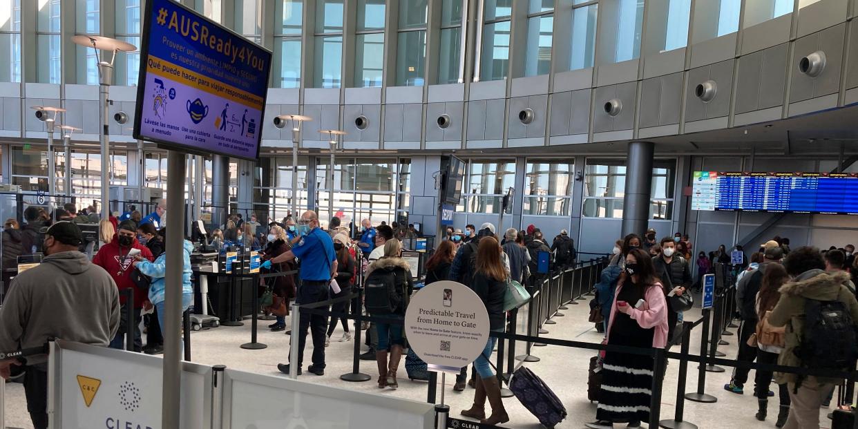 Travelers stand in line at a TSA security checkpoint at Austin-Bergstrom International Airport Friday, Feb. 19, 2021, in Austin, Texas.