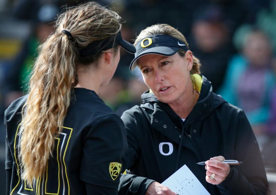 Oregon coach Melyssa Lombardi talks with pitcher Stevie Hansen during the Ducks' 7-4 loss to UCLA on March 25 at Jane Sanders Stadium in Eugene, Ore.