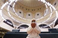 A Saudi man wearing a protective face mask performs the Al-Fajr prayer inside the Al-Rajhi Mosque, after the announcement of the easing of lockdown measures amid the coronavirus disease (COVID-19) outbreak, in Riyadh