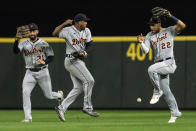 Detroit Tigers center fielder Riley Greene, left, second baseman Jonathan Schoop, center, and right fielder Victor Reyes allow a fly ball hit by Seattle Mariners' Julio Rodriguez to drop for a hit during the third inning of a baseball game, Monday, Oct. 3, 2022, in Seattle. (AP Photo/Stephen Brashear)