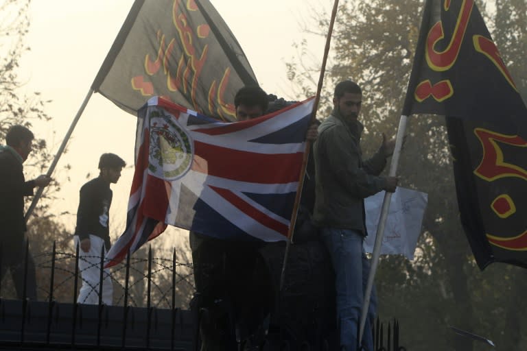 Iranian protesters take down the Union Jack as they break into the British embassy in Tehran on November 29, 2011