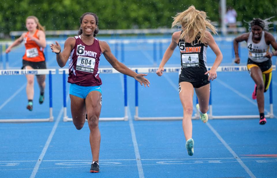 Tremont's Cambria Geyer smiles while crossing the finish line for victory in the 300-meter hurdles during the Class 1A State Track and Field Championships on Saturday, May 21, 2022 at Eastern Illinois University.