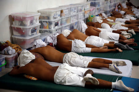 Drug dependents sleep with their shirts over their heads during a siesta at a dormitory for newly admitted patients at Central Luzon Drug Rehabilitation Center in Pampanga province in northern Philippines, October 7, 2016. REUTERS/Erik De Castro