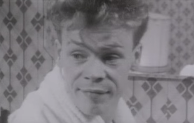 A close up of a man, in a black-and-white video clip