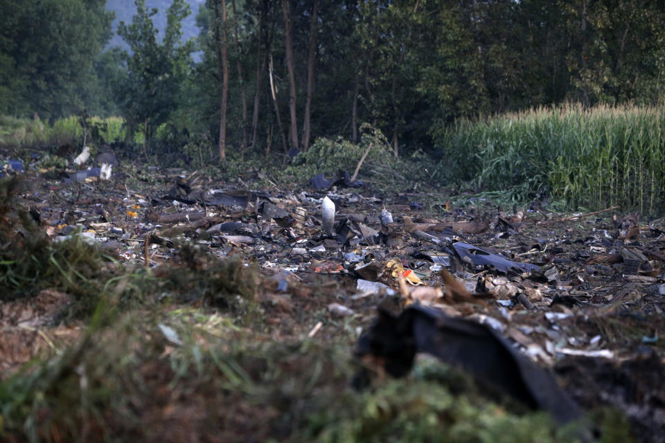 Debris of an Antonov cargo plane is seen in Palaiochori village in northern Greece, Sunday, July 17, 2022, after it reportedly crashed Saturday near the city of Kavala. The An-12, a Soviet-built turboprop aircraft operated by the Ukrainian cargo carrier Meridian, crashed late Saturday as Greek Civil Aviation authorities said the flight was heading from Serbia to Jordan. (AP Photo/Giannis Papanikos)