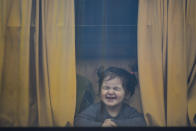 FILE - A child refugee fleeing the war from neighbouring Ukraine with her family grimaces as she sits in a bus after crossing the border by ferry at the Isaccea-Orlivka border crossing, in Romania, Friday, March 25, 2022. The U.N. refugee agency says more than 5 million refugees have fled Ukraine since Russian troops invaded the country. The agency announced the milestone in Europe’s biggest refugee crisis since World War II on Wednesday, April 20, 2022. (AP Photo/Andreea Alexandru, File)