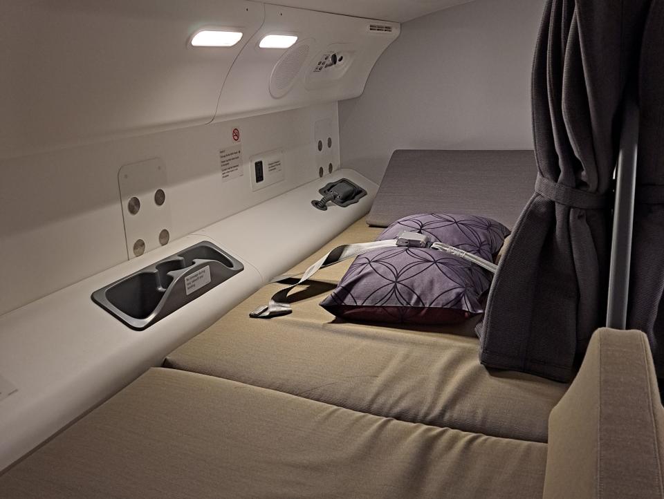 A pillow is held in place by a seat belt on one bunk in the pilot rest area on the Boeing 787.