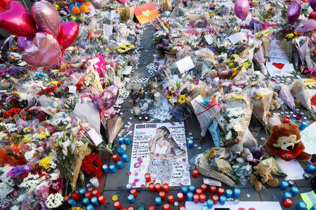 Flowers, messages and tokens are left in tribute to the victims of the attact on Manchester Arena, in central Manchester, Britain May 26, 2017. REUTERS/Stefan Wermuth