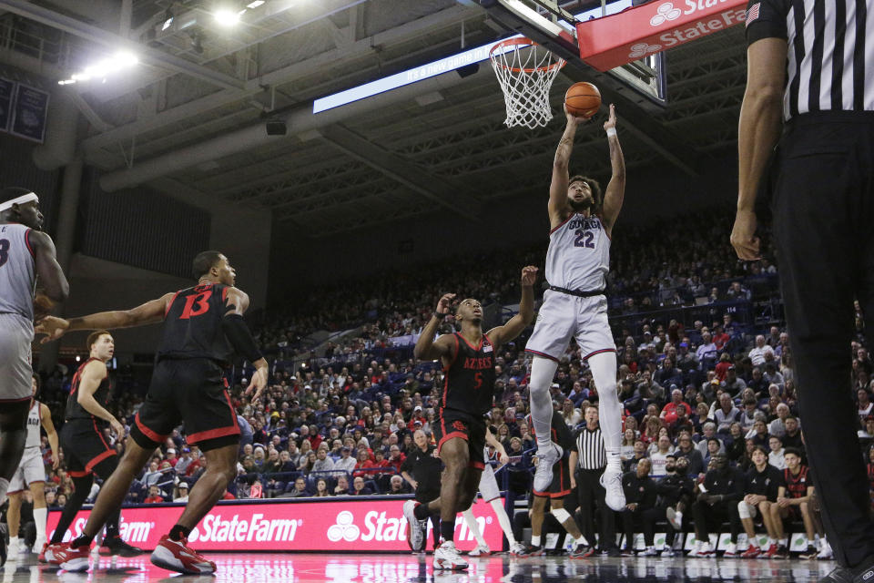 Gonzaga forward Anton Watson (22) shoots next to San Diego State guard Lamont Butler (5) during the first half of an NCAA college basketball game, Friday, Dec. 29, 2023, in Spokane, Wash. (AP Photo/Young Kwak)