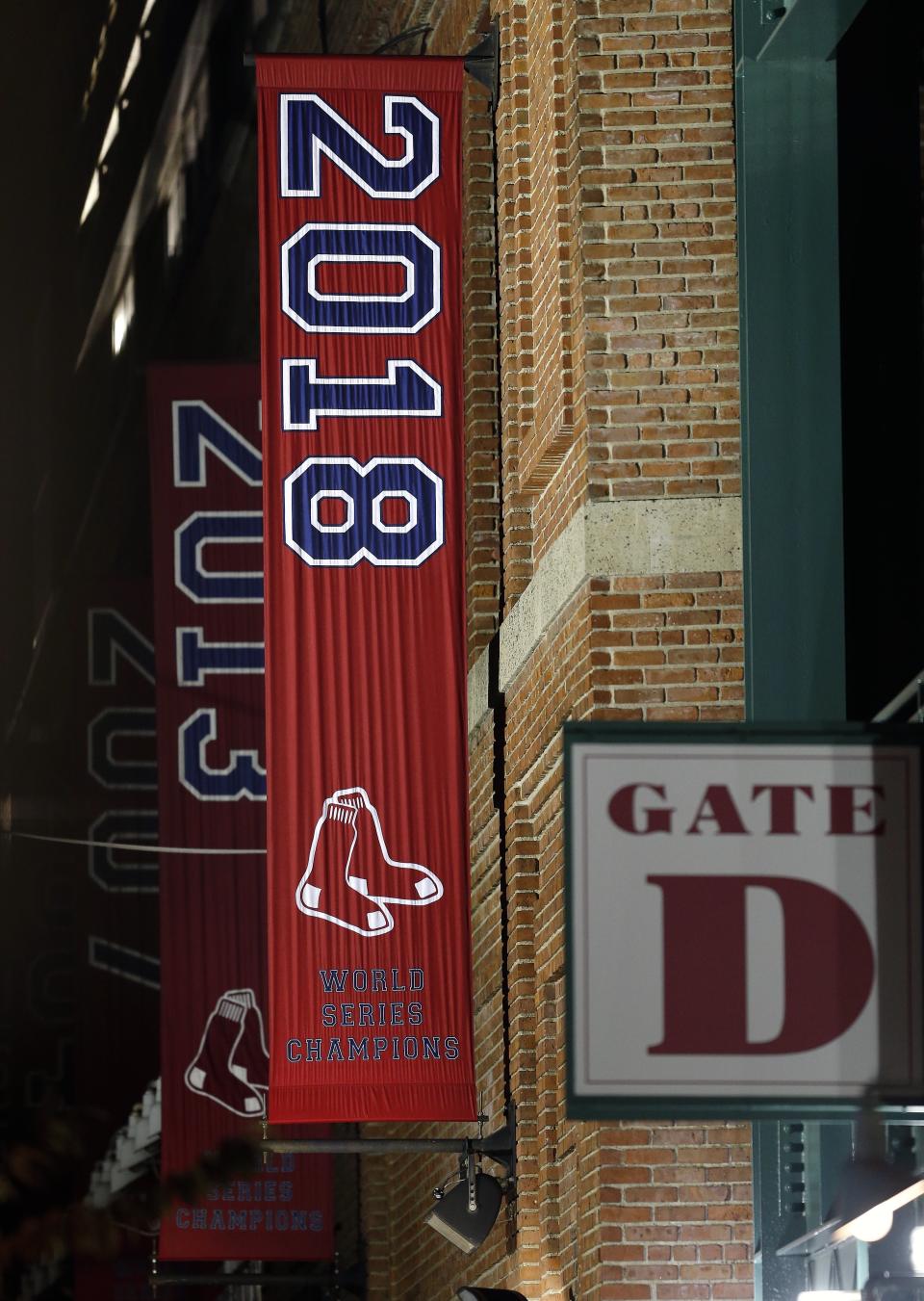 The 2018 World Series baseball championship banner hangs outside Fenway Park in Boston, Monday, Oct. 29, 2018. The Boston Red Sox won the series against the Los Angeles Dodgers on Sunday in Los Angeles. (AP Photo/Michael Dwyer)