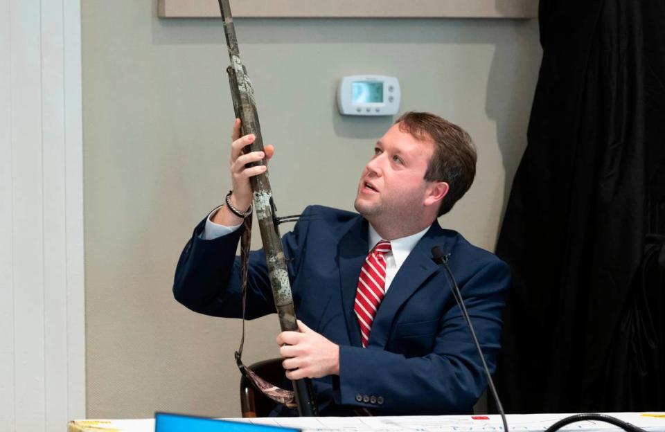 Firearms examiner Paul Greer removes a shotgun from an evidence box during Alex Murdaugh’s double murder trial at the Colleton County Courthouse in Walterboro, S.C., Tuesday, Feb. 3, 2023. The 54-year-old attorney is standing trial on two counts of murder in the shootings of his wife and son at their Colleton County home and hunting lodge on June 7, 2021. (Sam Wolfe/The State, Pool)