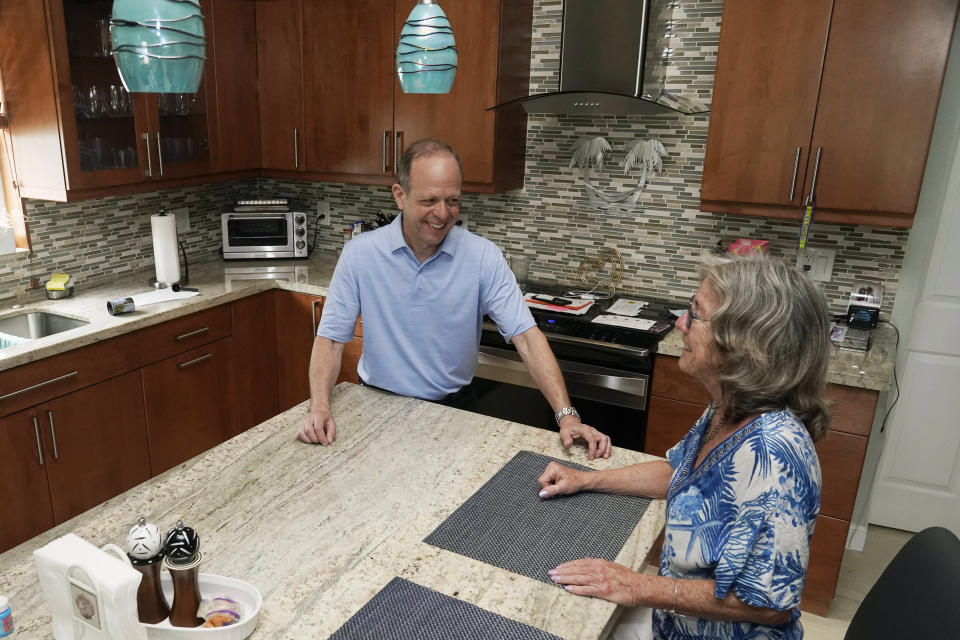 Mark Bendell and his wife Laurie talk in their kitchen, Monday, May 23, 2022, in Boca Raton, Fla. A stock market slump this year, which has taken big bites out of investors’ portfolios, including retirement plans like 401(k)s, is worrying Americans who are within a few years of retirement. (AP Photo/Marta Lavandier)