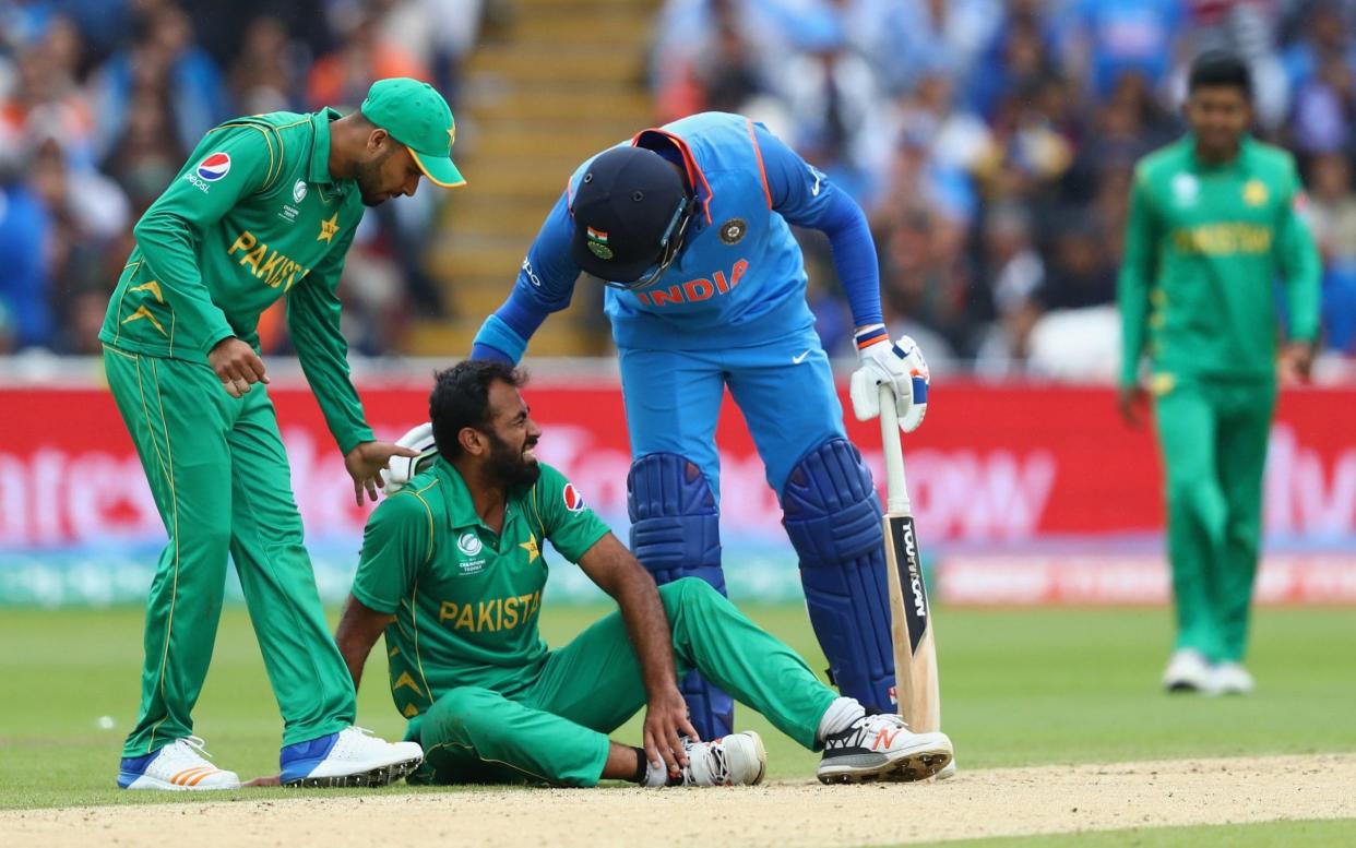Down and out: Wahab Riaz was one of TWO Pakistan bowlers to limp off the field as India put them to the sword - Getty Images Europe