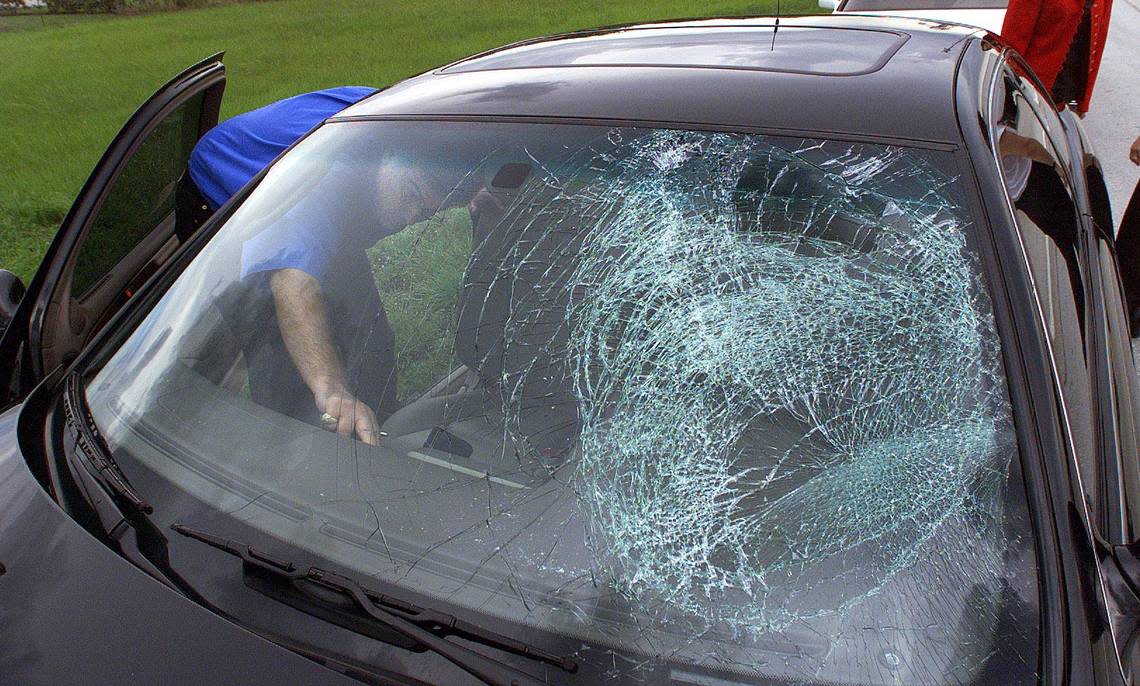 A Lexus windshield was broken when a truck tire hit it.