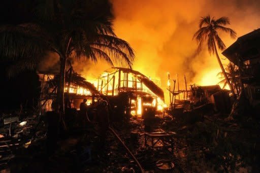 Firemen extinguish a fire engulfing houses in Sittwe, capital of the western state of Rakhine on June 15. Myanmar security forces opened fire on Rohingya Muslims, committed rape and stood by as rival mobs attacked each other during a recent wave of sectarian violence, a rights watchdog has said