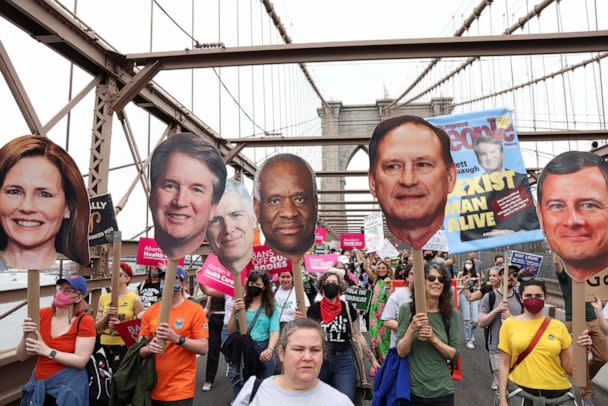 PHOTO: People carry images of Supreme Court Justices Amy Coney Barrett, Neil Gorsuch, Brett Kavanaugh, Clarence Thomas, Samuel Alito and John Roberts during protests against the overturning of Roe v. Wade, in New York City, May 14, 2022. (Caitlin Ochs/Reuters)
