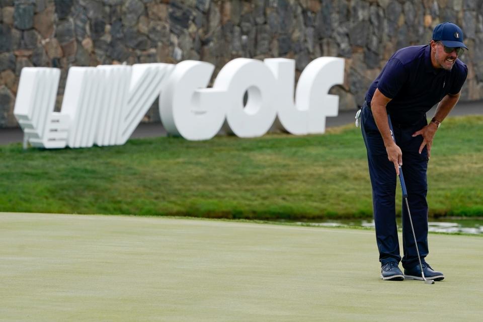 FILE - Phil Mickelson lines up a shot on the 18th hole during the first round of the Bedminster Invitational LIV Golf tournament in Bedminster, N.J., Friday, July 29, 2022.  Like the Saudi-backed LIV Golf league, critics describe the 2022 World Cup, which starts Sunday, as a classic case of "sportswashing" -- using sports to change a country or company's image. (AP Photo/Seth Wenig)