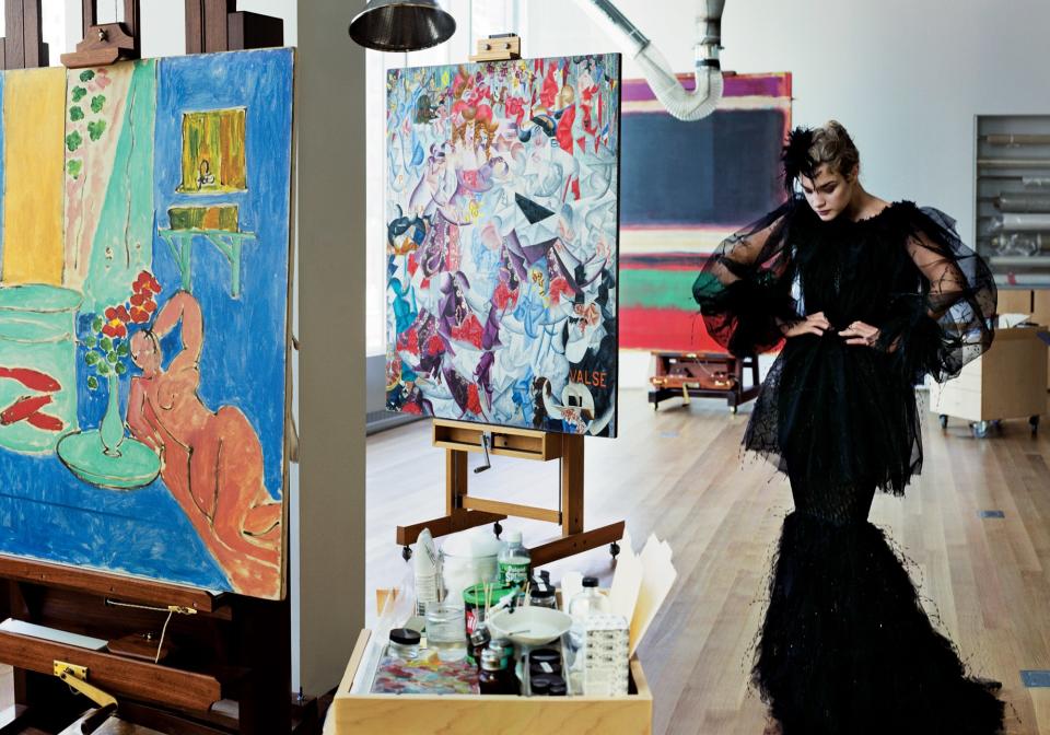 In MoMA’s “conservation room, Matisse’s Goldfish and Sculpture (1912), Gino Severini’s Dynamic Hieroglyphic of the Bal Tabarin (1912), and Rothko’s No. 3/No. 13 (1949) stand side by side with the artistry of the Chanel atelier’s expert craftspeople.” Natalia Vodianova in a Chanel Haute Couture black tulle jacket and bustier dress.