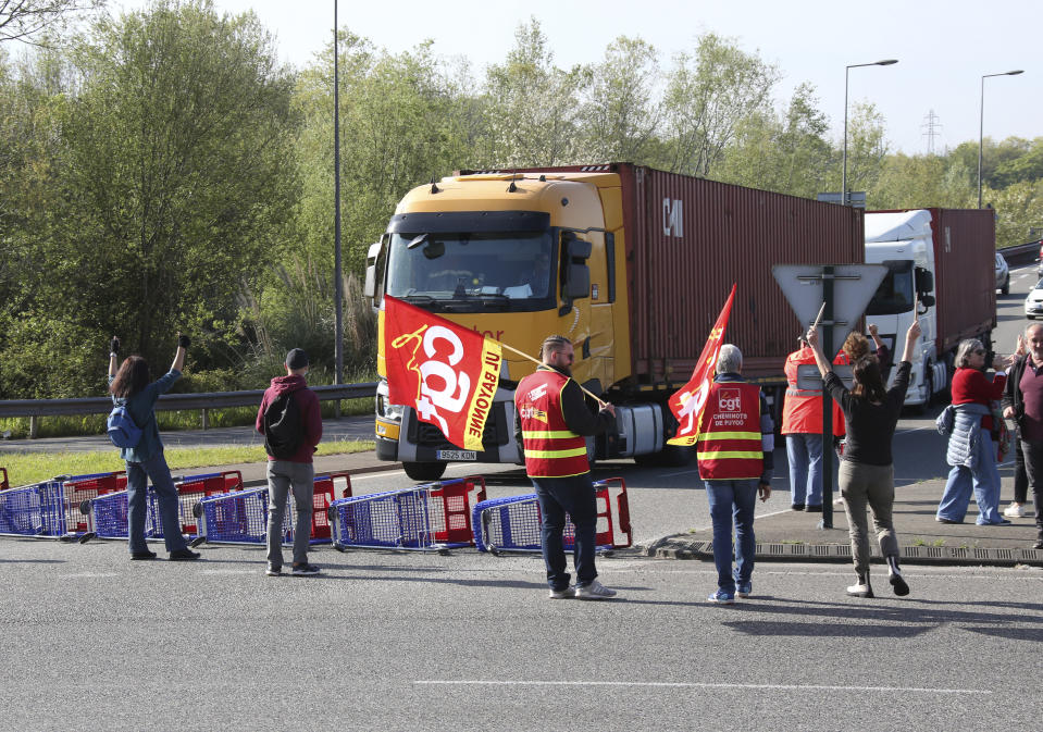 Demonstrators block the access to the Ikea store in protest against the pension reforms in Bayonne, southwestern France, Thursday, April 20, 2023. Union activists stage scattered actions to press France's government to scrap the new law raising the retirement age. (AP Photo/Bob Edme)