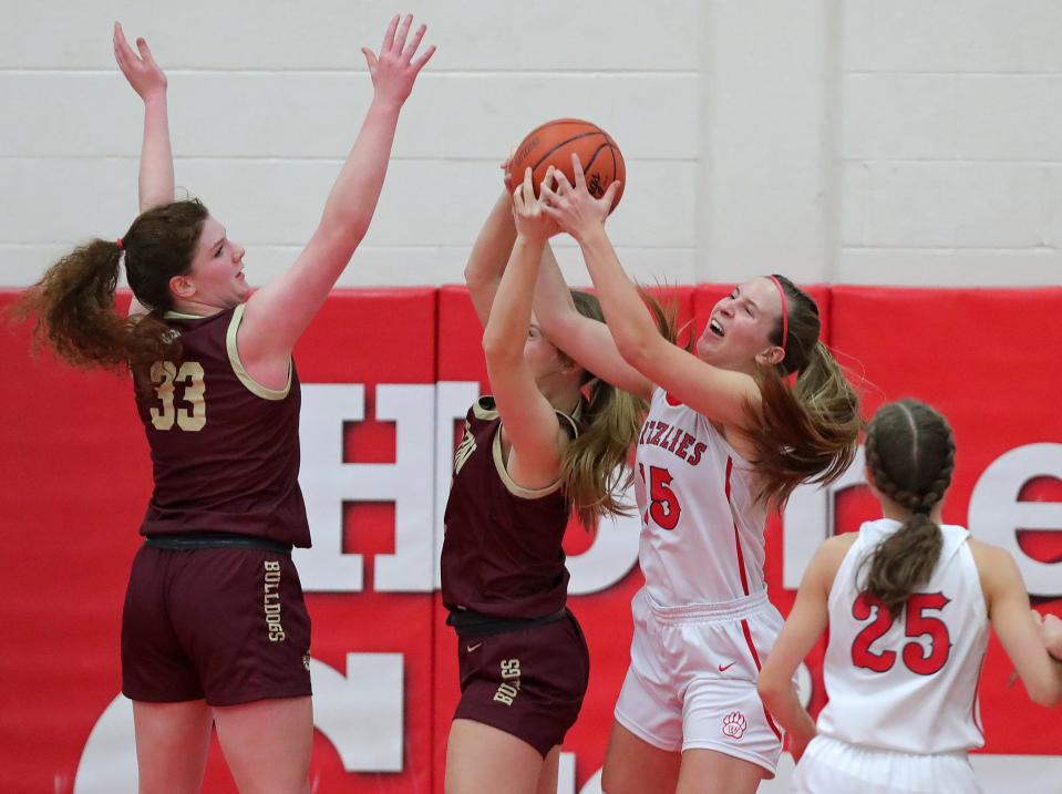Wadsworth's Brooke Baughman, right, fights for a rebound against Stow's Kennady Dodds, left, and Allie Knouff during the second half of a high school basketball game, Wednesday, Dec. 13, 2023, in Wadsworth, Ohio.