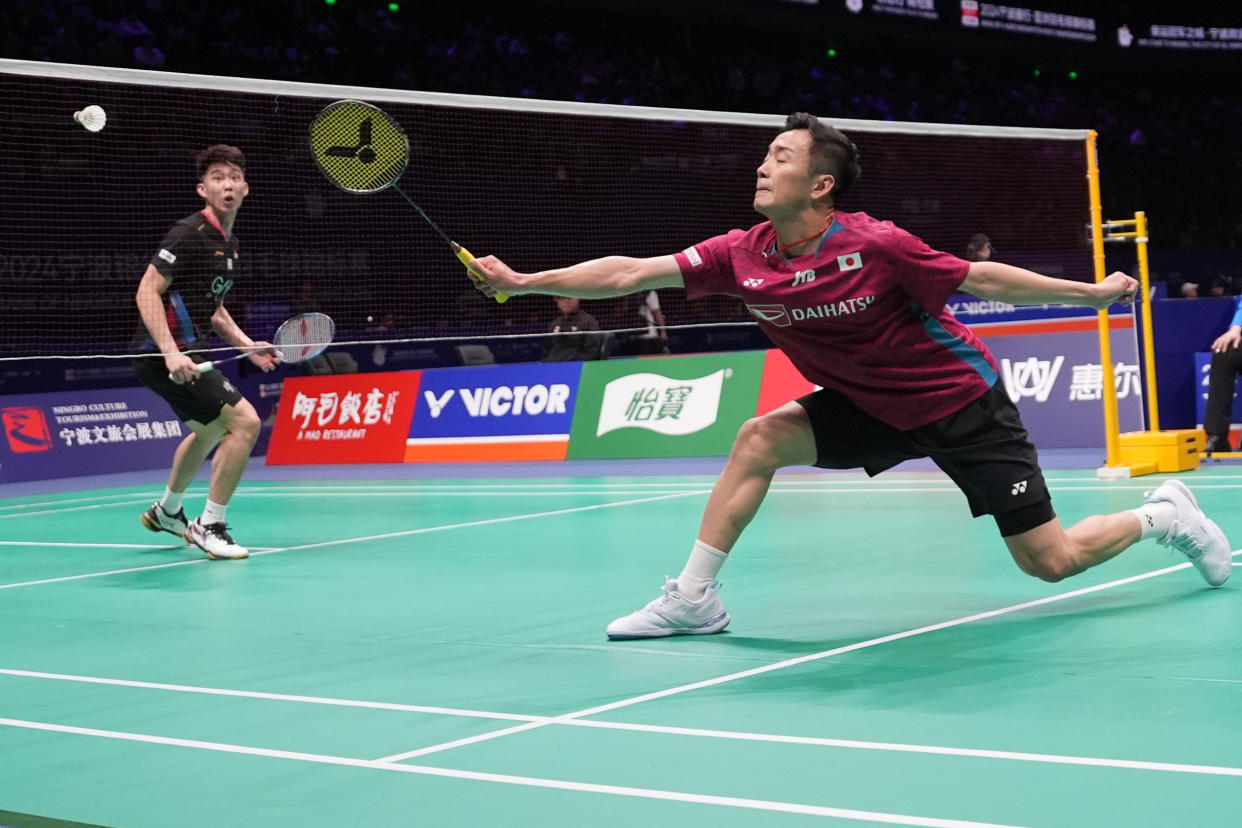 Singapore shuttler Loh Kean Yew (left) in action against Japan's Kenta Nishimoto at the 2024 Badminton Asia Championships at Ningbo Olympic Sports Centre.